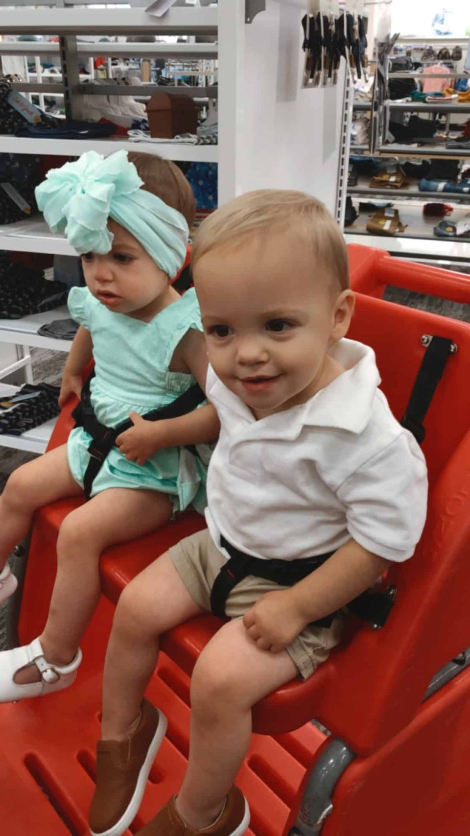 how to grocery shop with twins, boy and girl sitting in shopping cart
